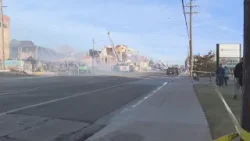 Smoke still rising, crowds gather as firefighters battle day-old 5-alarm apartment blaze