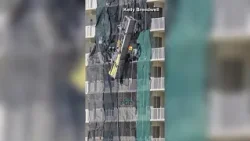 Scaffolding comes loose along the side of high-rise under construction in Florida Scaffolding comes loose along the side of high-rise under construction in Florida