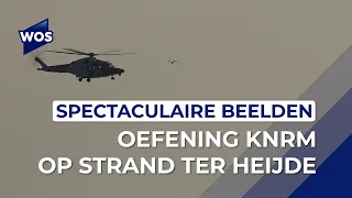 Helicopter hoists KNRM crew from the sea during exercise at Ter Heijde