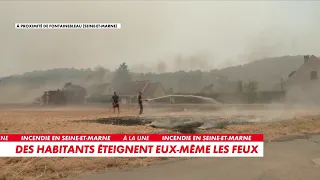 Residents attempt to put out the fire still spreading in Fontainebleau