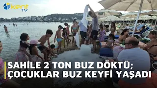 2 TONS OF ICE DUMPED ON THE BEACH; CHILDREN ENJOY A CHILLY TREAT