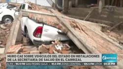 Two Ministry of Health vehicles damaged after a wall collapse