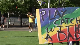 Group of dads play catch with LGBTQ+ youth