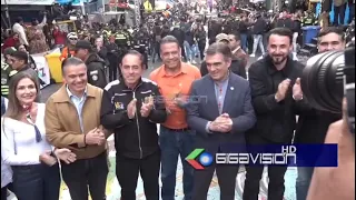 President, authorities, and local officials shake hands and embrace after participating.