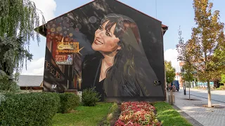 Basia Trzetrzelewska mural in Jaworzno. The painted portrait now has an information plaque