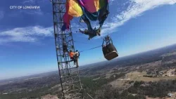 Two people were rescued after a hot air balloon crashed into a cell tower, officials said