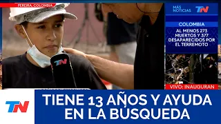 He is 13 years old and is helping search for survivors in the rubble