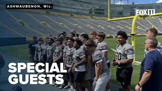 High school football team disrupted by tornado pays special visit to Packers practice