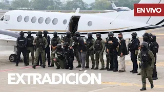 Costa Rican officials pose in front of plane carrying extradited individuals