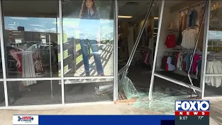 Vehicle crashes through clothing store off Halls Mill Road, officials say