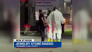 Jewelry store raided in Mandarin, video from nearby business shows man in handcuffs