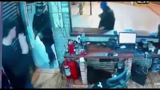 Violent robbery caught on camera: four men storm a bar
