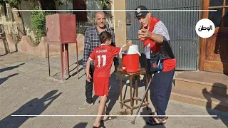 Distributing sherbet to citizens in celebration of Egypt's World Cup qualification