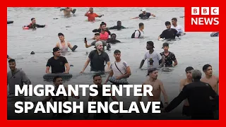 Thousands of migrants try to enter Spanish enclave of Ceuta from Morocco | BBC News