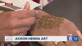 Kenny looks at Akron Henna art