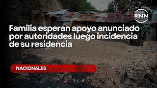 Families await aid announced by authorities following the incident at their homes